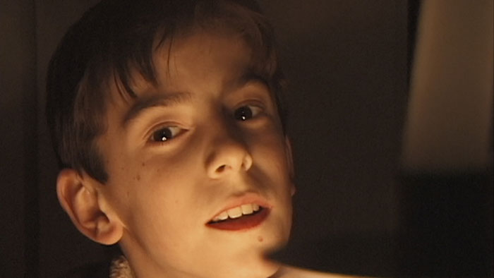 Adrian McElwee as a child in archival footage from the documentary Remake.