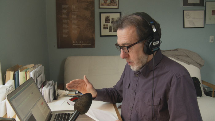 Ross McElwee records narration at his home desk in the documentary Remake.