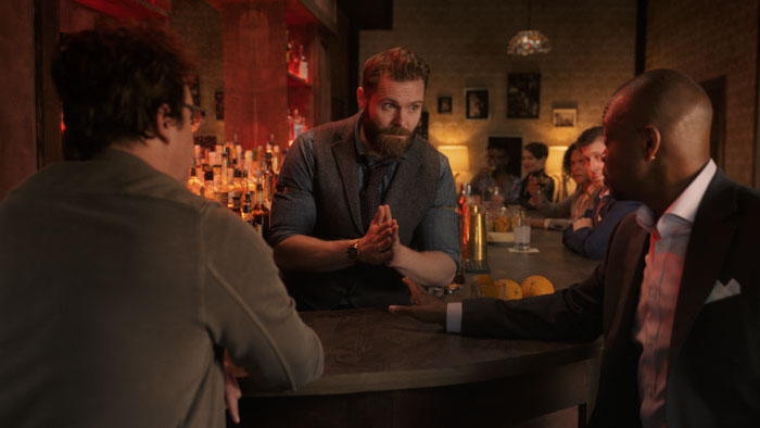 David, Coleman, and bartender Christian face off at the bar in Resentment.