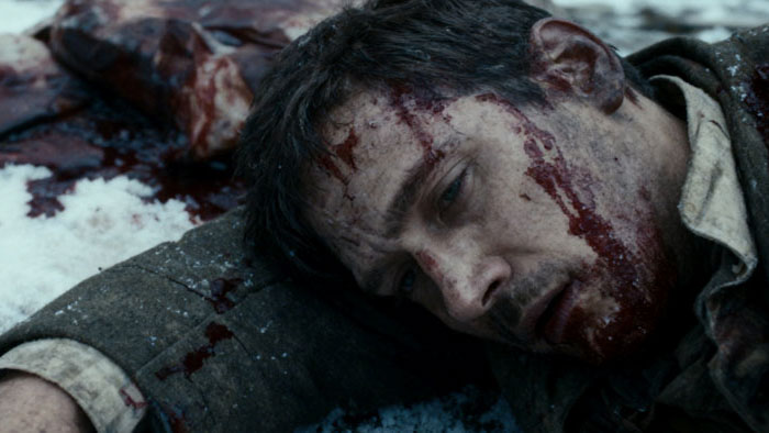 A wounded father lies bloodied in the snow after the attack in Snow Colored Ashes.