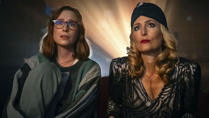 Kris (Hannah Einbinder) and Billy Presley (Gillian Anderson) watch a screening together in Teenage Sex and Death at Camp Miasma.