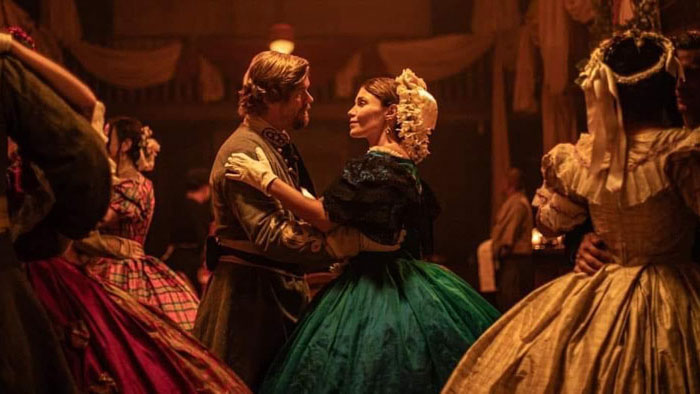 A couple in Confederate-era formal wear dances at a candlelit ball in The Legend of Van Dorn.