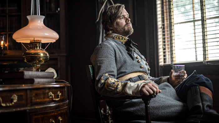 Lee Wilson as Gen. Earl Van Dorn drinks whiskey by lamplight in The Legend of Van Dorn.
