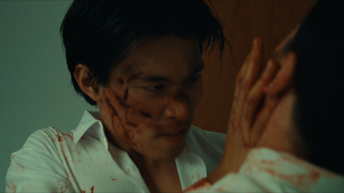 A bloodied Kevin Ng (Benjamin Ting) confronts his boss in VISA.