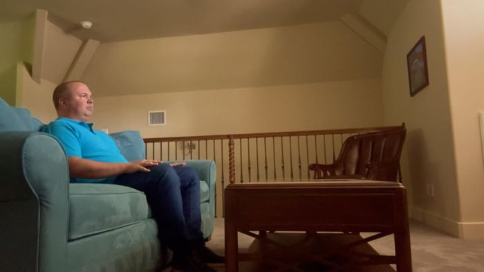 Leo Emerson (Matthew Paris) sits on a couch in a quiet room in Words to Paper.