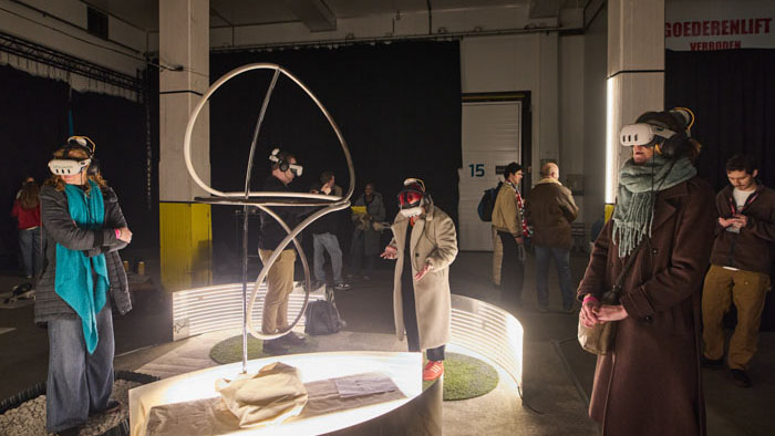 Visitors wear VR headsets to experience Cycle at IFFR's Katoenhuis venue.