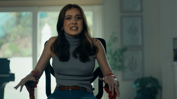 Ashley (Grace Kaufman) sits bound and distressed in a living room in Influence.