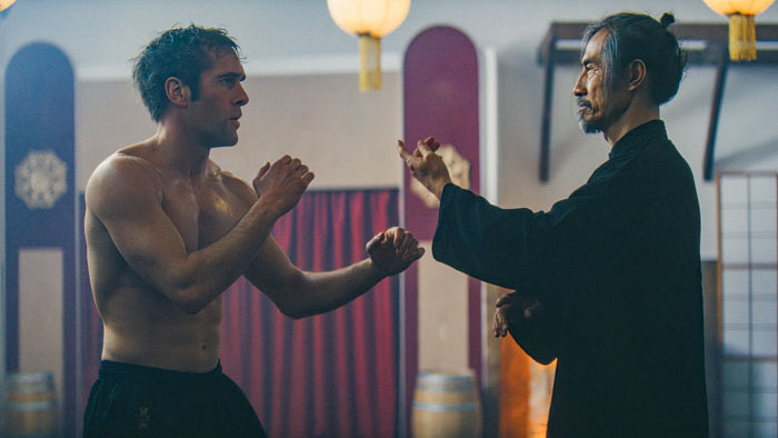 Joe (Mathis Landwehr) and Wu (Yanlong Li) face off in a martial arts stance in Lion Fist.