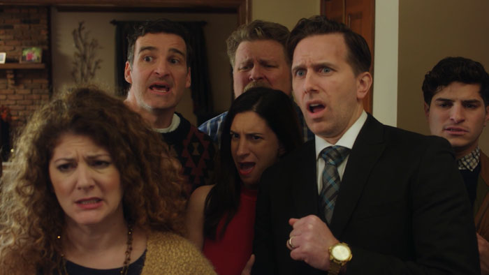 The extended family reacts in shock during a chaotic Thanksgiving gathering in The Family Recipe.